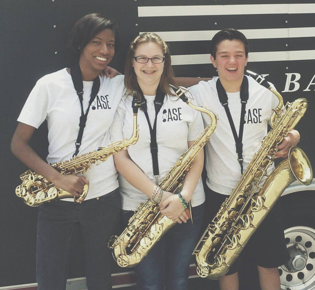 3 ASEYouth participants posing with their saxophones